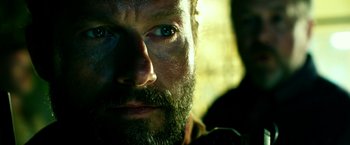 Movie still from “13 Hours” (2016), directed by Michael Bay – A man with a beard; Close Up shot, Over the shoulder angle