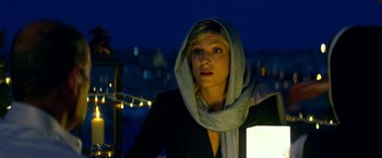 Movie still from “13 Hours” (2016), directed by Michael Bay – A woman wearing a hooded jacket and a scarf; Close Up shot, Low angle