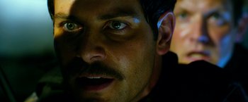 Movie still from “13 Hours” (2016), directed by Michael Bay – A person with a mustache; Extreme Close Up shot, Over the shoulder angle