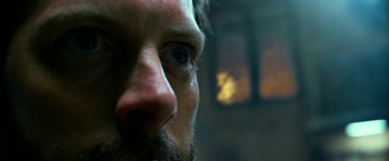 Movie still from “13 Hours” (2016), directed by Michael Bay – A man with a beard and blue eyes; Extreme Close Up shot, Low angle