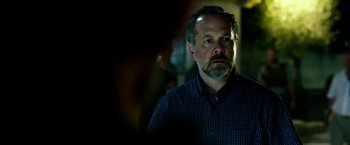 Movie still from “13 Hours” (2016), directed by Michael Bay – A person wearing a shirt; Close Up shot, Low angle