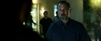 Movie still from “13 Hours” (2016), directed by Michael Bay – A man with a goatee standing in a room; Close Up shot, Low angle