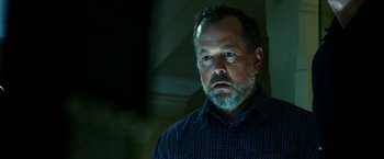 Movie still from “13 Hours” (2016), directed by Michael Bay – A person wearing a shirt; Close Up shot, Low angle