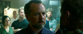 Movie still from “13 Hours” (2016), directed by Michael Bay – A person wearing a plaid shirt; Close Up shot, Over the shoulder angle