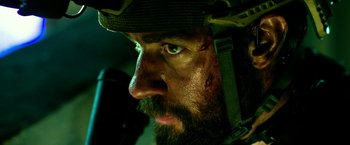 Movie still from “13 Hours” (2016), directed by Michael Bay – A person with a helmet on; Close Up shot, Low angle