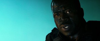 Movie still from “13 Hours” (2016), directed by Michael Bay – A person wearing a black jacket; Close Up shot, Low angle