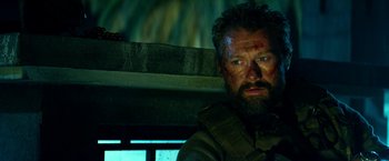 Movie still from “13 Hours” (2016), directed by Michael Bay – A person wearing a helmet; Close Up shot, Low angle