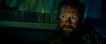 Movie still from “13 Hours” (2016), directed by Michael Bay – A person with a beard; Close Up shot, Over the shoulder angle