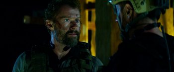 Movie still from “13 Hours” (2016), directed by Michael Bay – A person wearing a helmet; Close Up shot, Over the shoulder angle