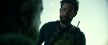 Movie still from “13 Hours” (2016), directed by Michael Bay – A person with a gun on his shoulder; Close Up shot, Over the shoulder angle
