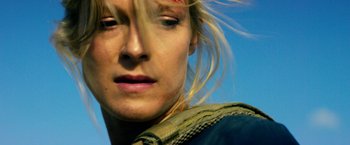 Movie still from “13 Hours” (2016), directed by Michael Bay – A woman's face in a field; Close Up shot, Low angle