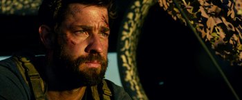 Movie still from “13 Hours” (2016), directed by Michael Bay – A person with a scar on his face; Close Up shot, Low angle