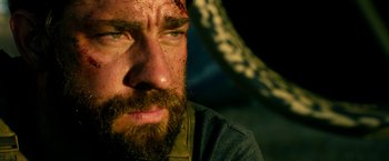 Movie still from “13 Hours” (2016), directed by Michael Bay – A person with a beard; Close Up shot, Low angle