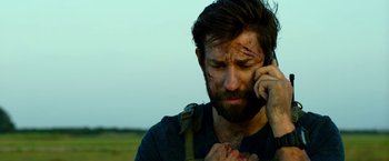 Movie still from “13 Hours” (2016), directed by Michael Bay – A person talking on a cell phone; Close Up shot, Over the shoulder angle