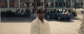 Movie still from “2 Guns” (2013), directed by Baltasar Kormákur – A man standing in front of a store window; Close Up shot, Over the shoulder angle