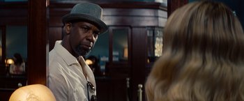 Movie still from “2 Guns” (2013), directed by Baltasar Kormákur – A man wearing a hat standing next to a woman; Close Up shot, Over the shoulder angle