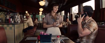 Movie still from “2 Guns” (2013), directed by Baltasar Kormákur – A waitress writing on a menu in a restaurant; Medium shot, Over the shoulder angle