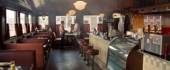 Movie still from “2 Guns” (2013), directed by Baltasar Kormákur – Two men standing at a counter in a restaurant; Wide shot, High angle