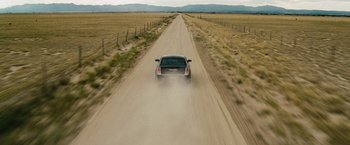 Movie still from “2 Guns” (2013), directed by Baltasar Kormákur – A car driving down a dirt road in the middle of nowhere; Extreme Wide shot, High angle