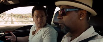 Movie still from “2 Guns” (2013), directed by Baltasar Kormákur – Two men in a car looking at each other; Close Up shot, Over the shoulder angle