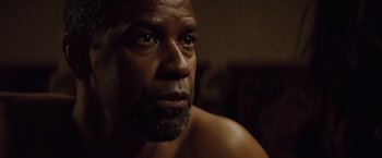 Movie still from “2 Guns” (2013), directed by Baltasar Kormákur – A person with a beard looking into the distance; Close Up shot, Over the shoulder angle