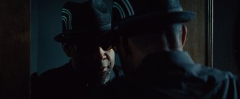 Movie still from “2 Guns” (2013), directed by Baltasar Kormákur – A man in a black hat and a man in a black hat; Close Up shot, Over the shoulder angle