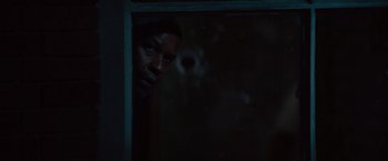 Movie still from “2 Guns” (2013), directed by Baltasar Kormákur – A man looking out of a window at night; Close Up shot, Over the shoulder angle