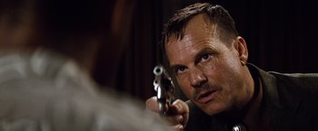 Movie still from “2 Guns” (2013), directed by Baltasar Kormákur – A person holding a gun; Close Up shot, Over the shoulder angle