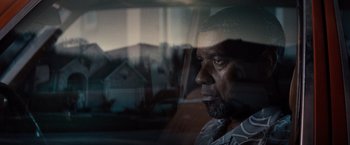Movie still from “2 Guns” (2013), directed by Baltasar Kormákur – A person looking out of a car window; Close Up shot, Over the shoulder angle