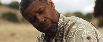 Movie still from “2 Guns” (2013), directed by Baltasar Kormákur – An older black man with a beard is looking down; Close Up shot, Low angle