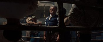 Movie still from “2 Guns” (2013), directed by Baltasar Kormákur – An old man wearing a vest and a neck tie; Medium shot, Low angle