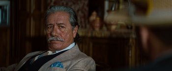 Movie still from “2 Guns” (2013), directed by Baltasar Kormákur – An older man in a suit and a tie; Close Up shot, Low angle