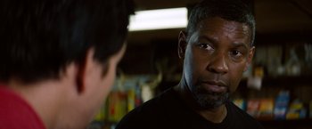 Movie still from “2 Guns” (2013), directed by Baltasar Kormákur – A man in a black shirt is talking to another man; Close Up shot, Over the shoulder angle