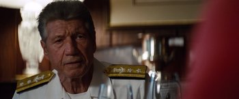 Movie still from “2 Guns” (2013), directed by Baltasar Kormákur – An older man wearing a white shirt and a yellow hat; Close Up shot, Over the shoulder angle