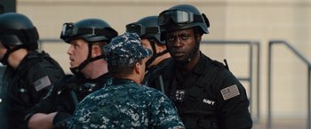 Movie still from “2 Guns” (2013), directed by Baltasar Kormákur – A group of men in black uniforms and helmets; Close Up shot, Over the shoulder angle