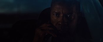 Movie still from “2 Guns” (2013), directed by Baltasar Kormákur – A person with his hand on his chin; Close Up shot, Over the shoulder angle