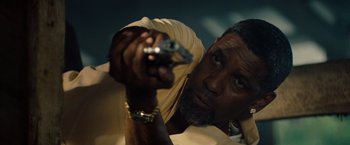 Movie still from “2 Guns” (2013), directed by Baltasar Kormákur – A person holding a gun; Close Up shot, Low angle