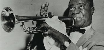 A black and white photo of a man playing a trumpet