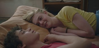 Movie still from “20th Century Women” (2016), directed by Mike Mills – A woman and a boy laying on a bed together; Close Up shot, Over the shoulder angle