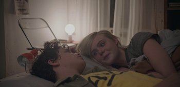 Movie still from “20th Century Women” (2016), directed by Mike Mills – A young man and a young woman laying in a bed together; Close Up shot, Over the shoulder angle