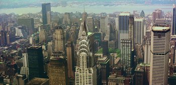 Movie still from “20th Century Women” (2016), directed by Mike Mills – An aerial view of a city with skyscrapers; Extreme Wide shot, High angle