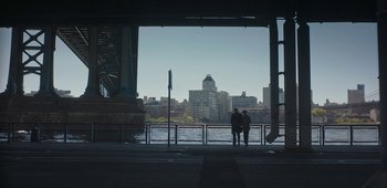 Movie still from “20th Century Women” (2016), directed by Mike Mills – Two people standing on a bridge looking out over the water; Extreme Wide shot, Over the shoulder angle