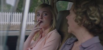 Movie still from “20th Century Women” (2016), directed by Mike Mills – A woman smoking a cigarette while sitting in the back of a car; Close Up shot, Over the shoulder angle