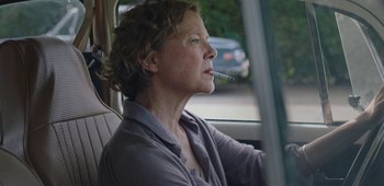 Movie still from “20th Century Women” (2016), directed by Mike Mills – A woman sitting in a car with a cigarette in her mouth; Close Up shot, Low angle