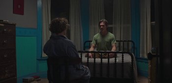 Movie still from “20th Century Women” (2016), directed by Mike Mills – A man sitting on a bed in front of a woman; Wide shot, High angle