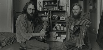 Movie still from “20th Century Women” (2016), directed by Mike Mills – A couple of men sitting on the ground in a room; Medium shot, Low angle