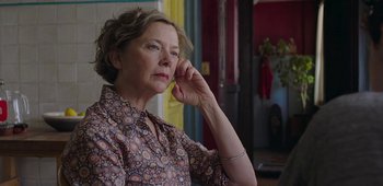 Movie still from “20th Century Women” (2016), directed by Mike Mills – An older woman is holding a cell phone up to her ear; Close Up shot, Over the shoulder angle