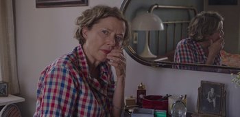 Movie still from “20th Century Women” (2016), directed by Mike Mills – A woman sitting in front of a bathroom mirror; Close Up shot, Over the shoulder angle