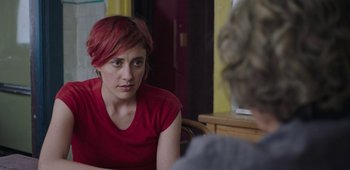 Movie still from “20th Century Women” (2016), directed by Mike Mills – A woman with red hair sitting in front of another woman; Close Up shot, Over the shoulder angle