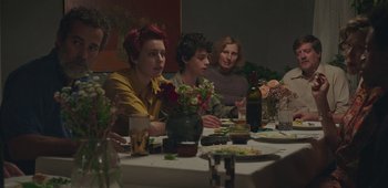 Movie still from “20th Century Women” (2016), directed by Mike Mills – A group of people sitting at a dinner table; Medium shot, Over the shoulder angle